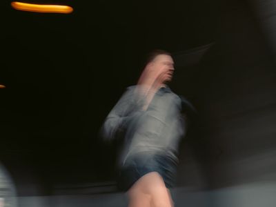 Blurred motion of a person performing a dynamic exercise.